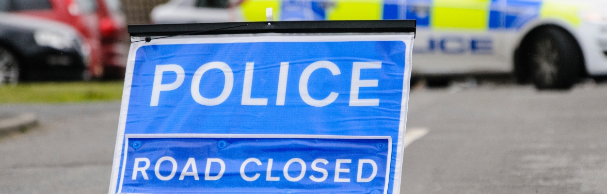Police road closed sign