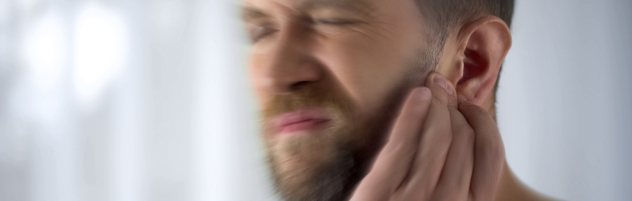 Man with discomfort to ear